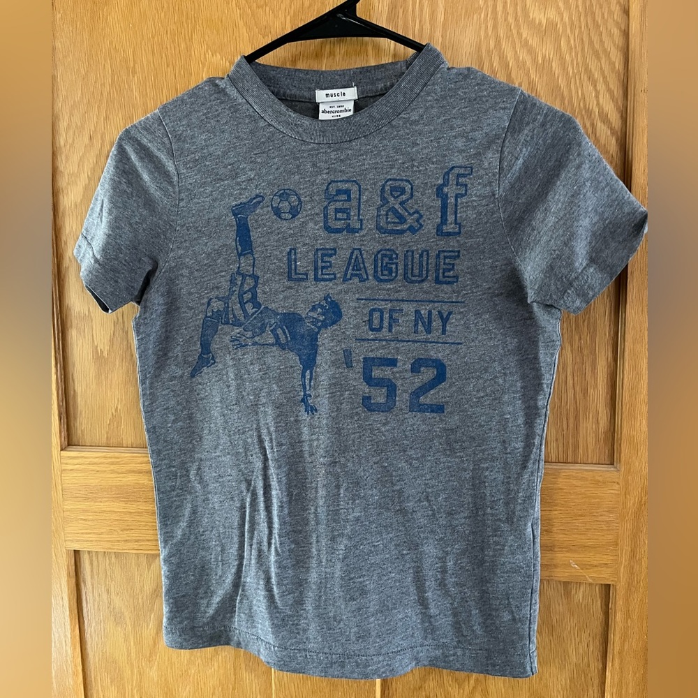- Abercrombie kids graphic t-shirt soccer gray & blue, size M